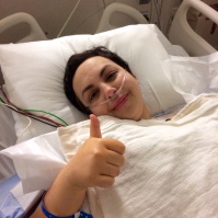 In the recovery room and already giving the thumbs up. That's because the anesthesia was still working.